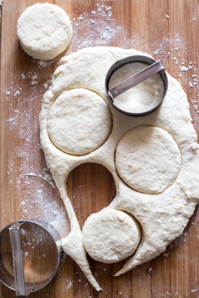 cutting out the dough with a round cookie cutter