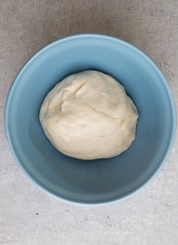 the dough before the first rise in a blue bowl