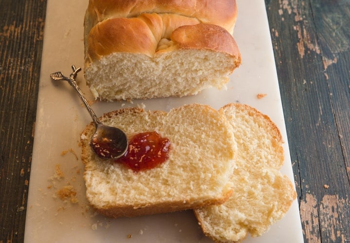 brioche bread with 2 slices and jam and a spoon
