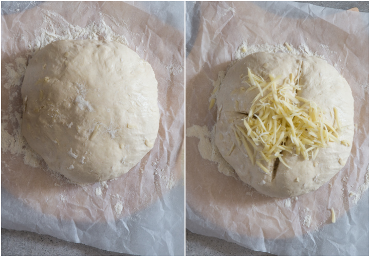 the dough after rising and scoring and topping with cheese