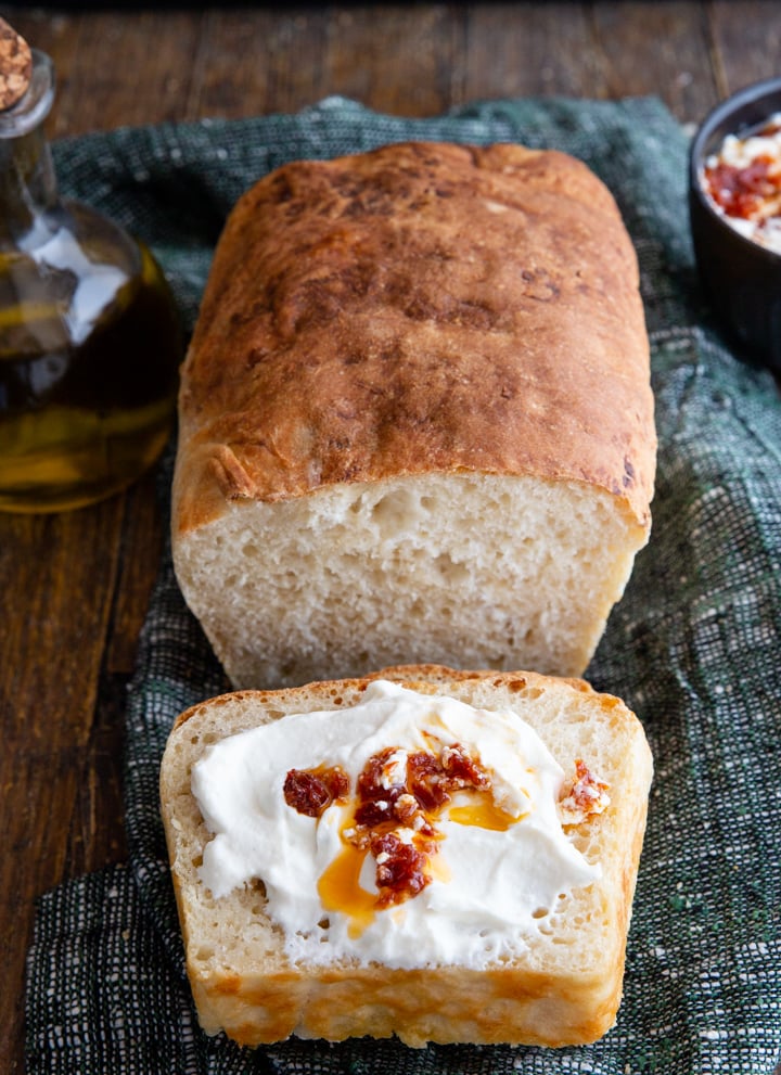 ricotta bread with a slice spread with ricotta and dried tomatoes