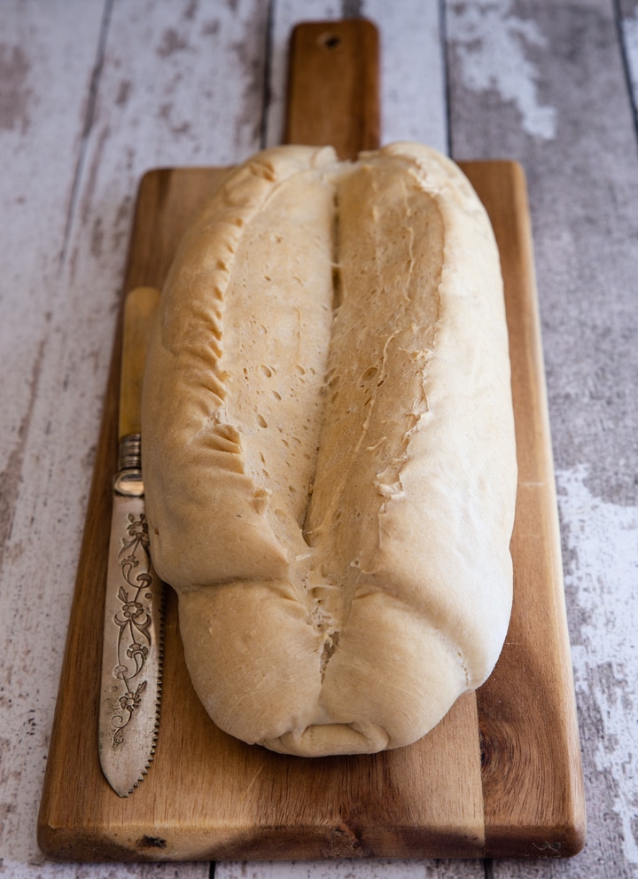biove bread just baked on a wooden board with a knife