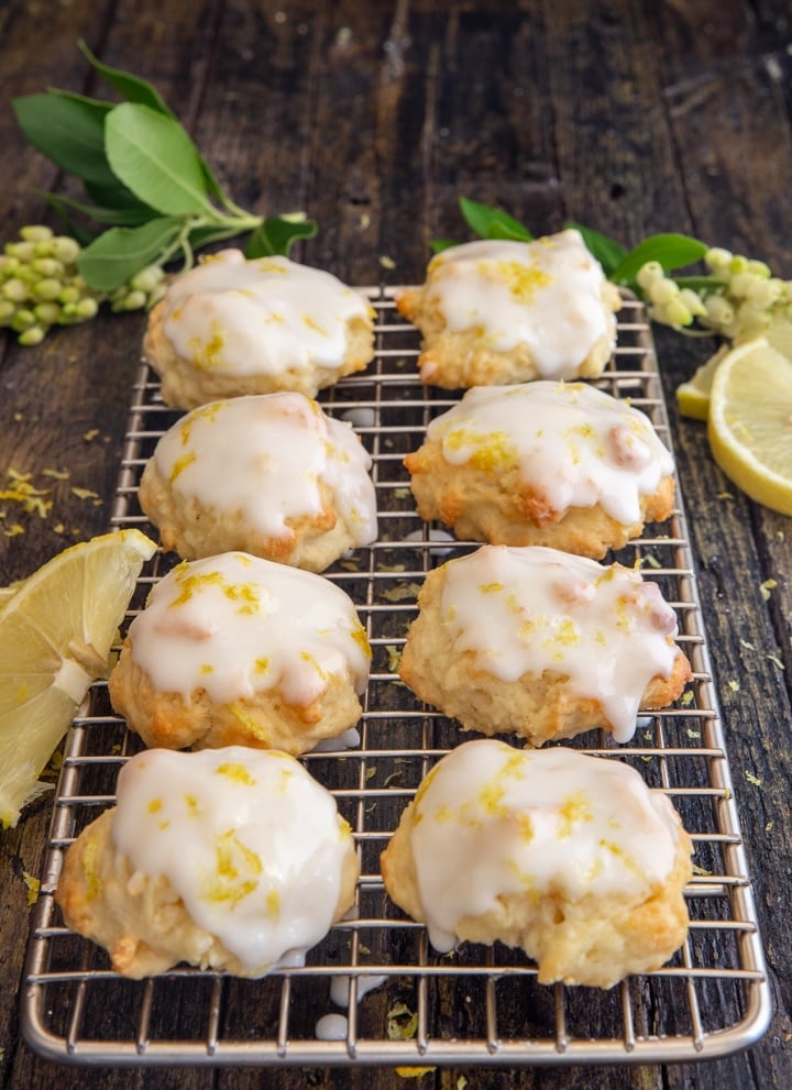 ricotta cookies on a wire rack with slices of lemon