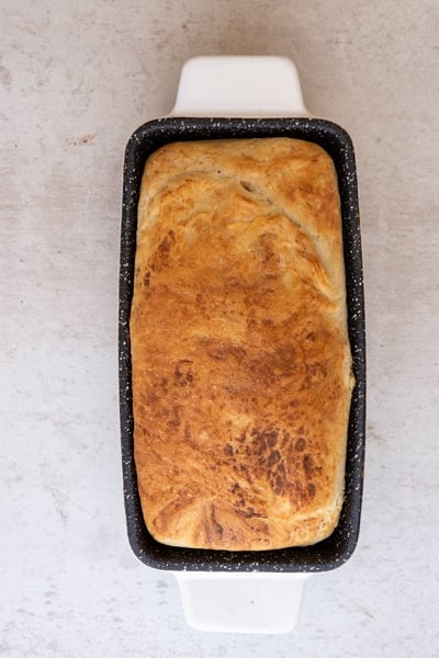 the baked ricotta bread in a white loaf pan