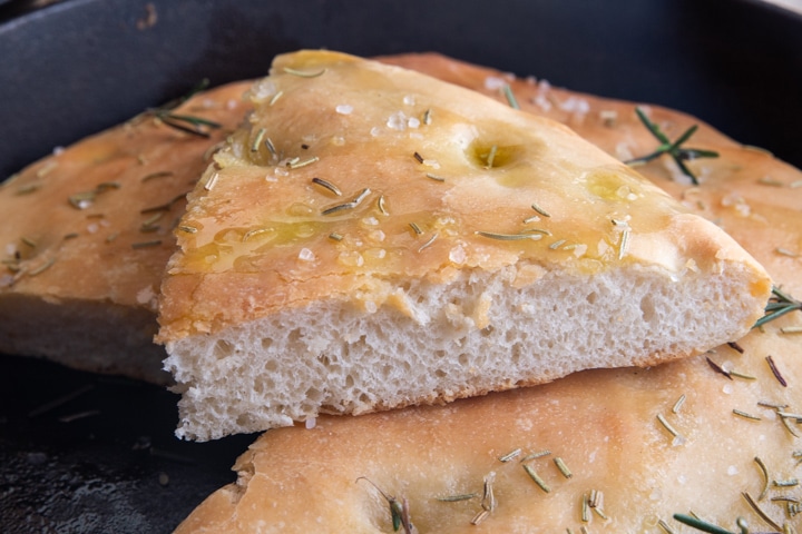 a slice of focaccia on the large focaccia.