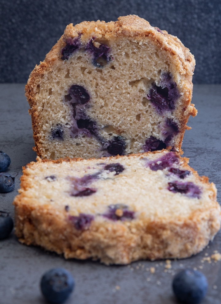blueberry bread with 1 slice cut.