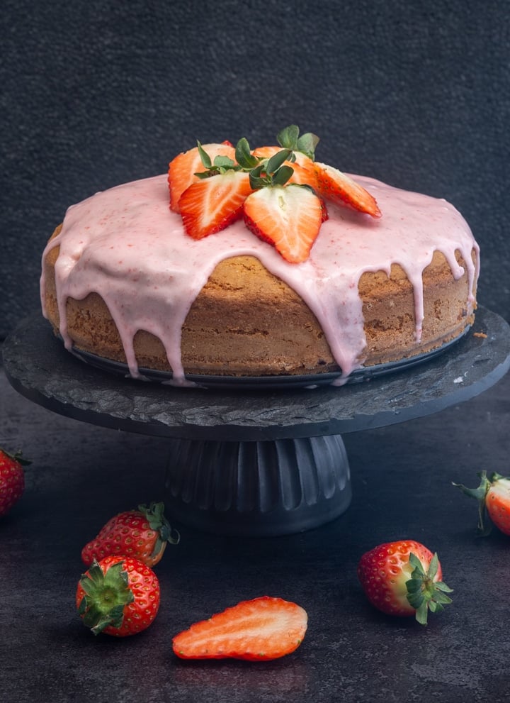 strawberry cake on a black cake stand