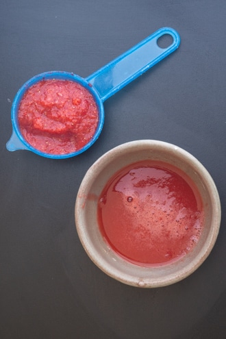 strawberry puree in a bowl with sifter.