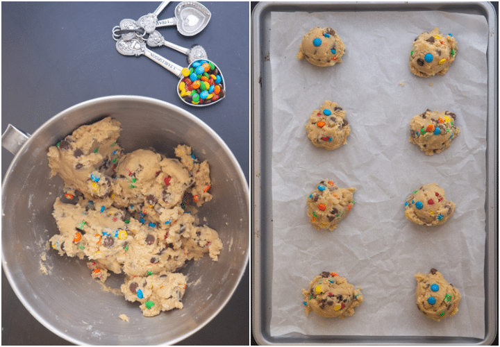 M&ms mixed into the batter & scoops on a parchment paper lined cookie sheet.