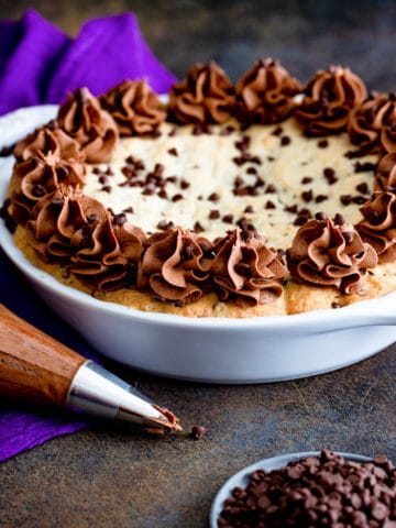 Decorated chocolate chip pie in a white pan.