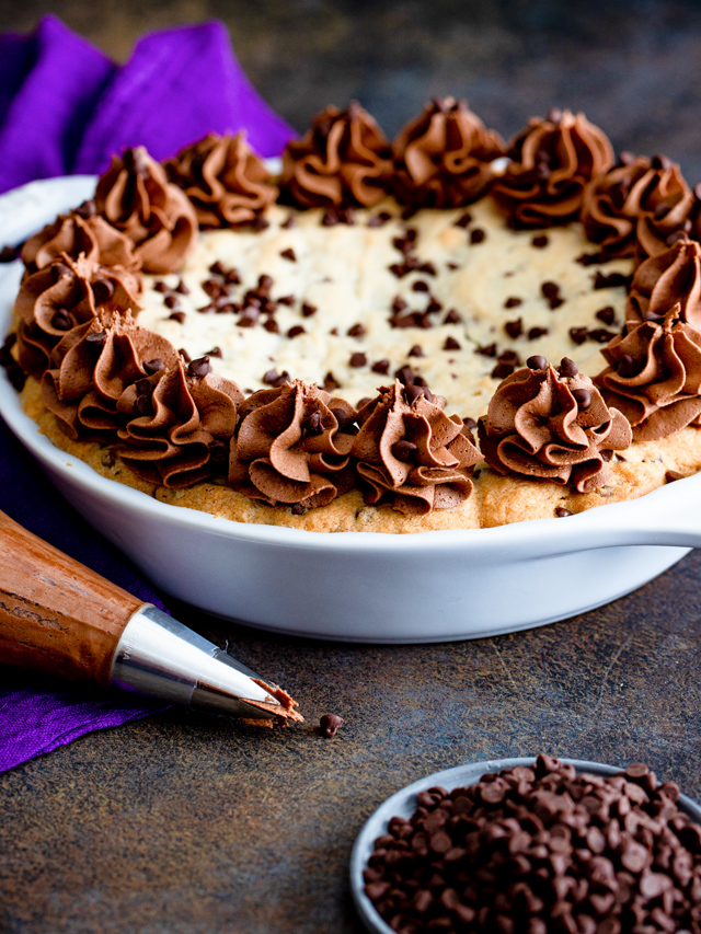 Decorated chocolate chip pie in a white pan.