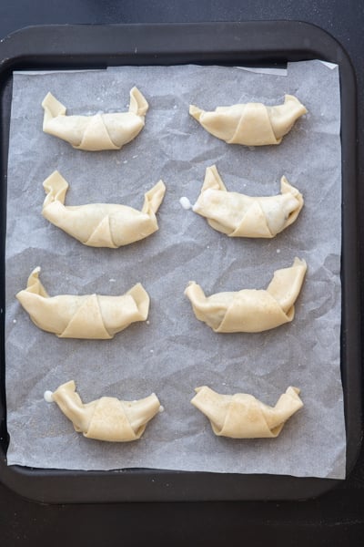 Crescents rolled on a cookie sheet and brushed with milk & sprinkled with sugar before baking.