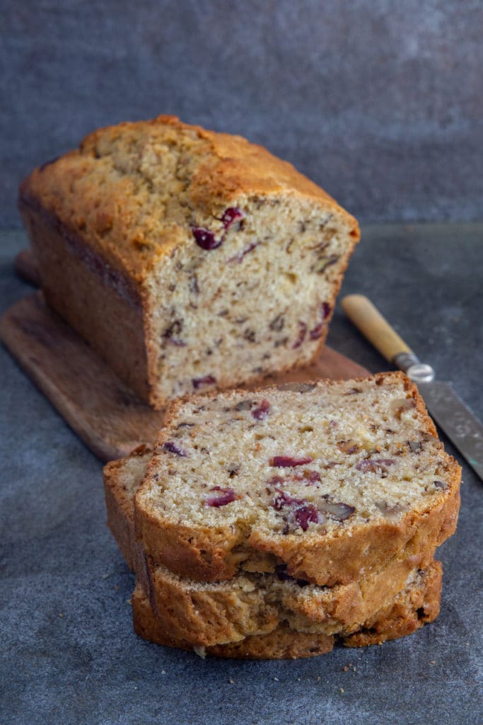 Cranberry nut bread with 2 slices cut.