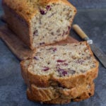 Cranberry nut bread with 2 slices cut.