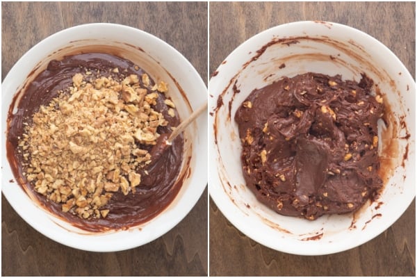 Mixing in the nuts into the melted chocolate and mixed together in a white bowl.