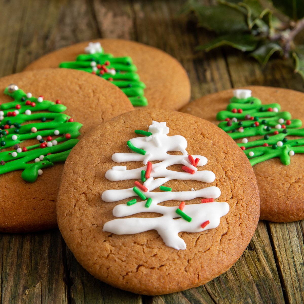 4 gingerbread cookies on a green board.