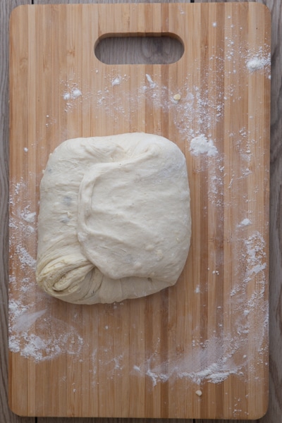 The dough folded on a flat surface.