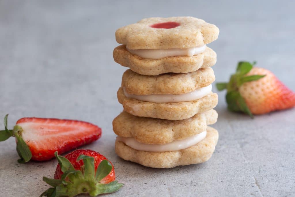 Cookies stacked with strawberries.