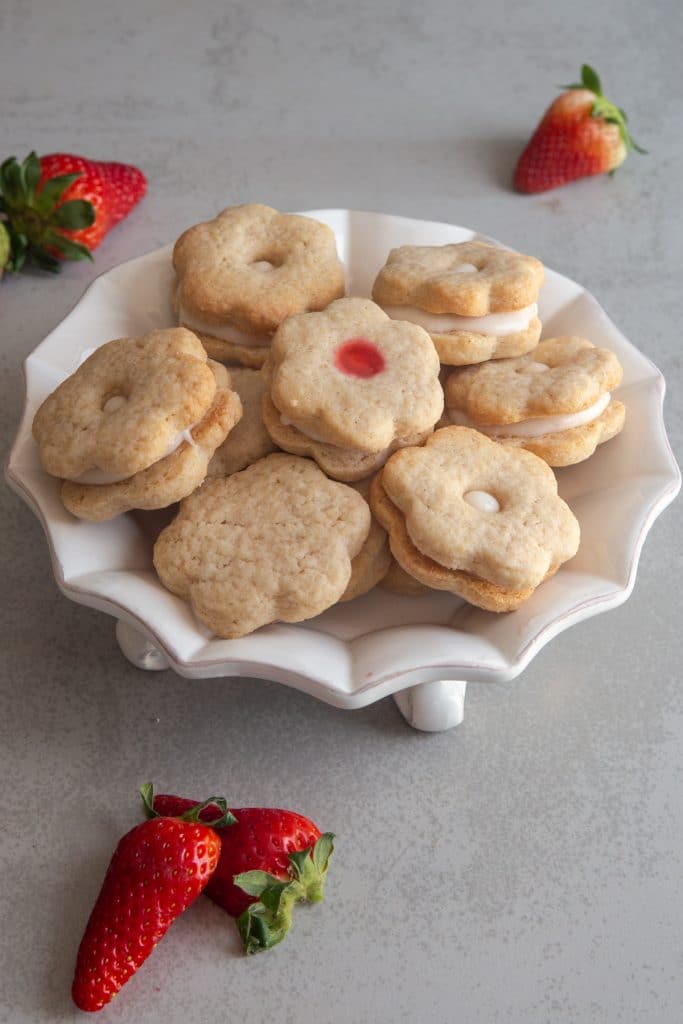 Strawberry sandwich Cookies in a white dish.