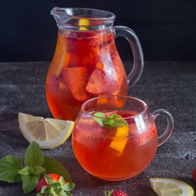 Strawberry sangria in a jug and in a glass.