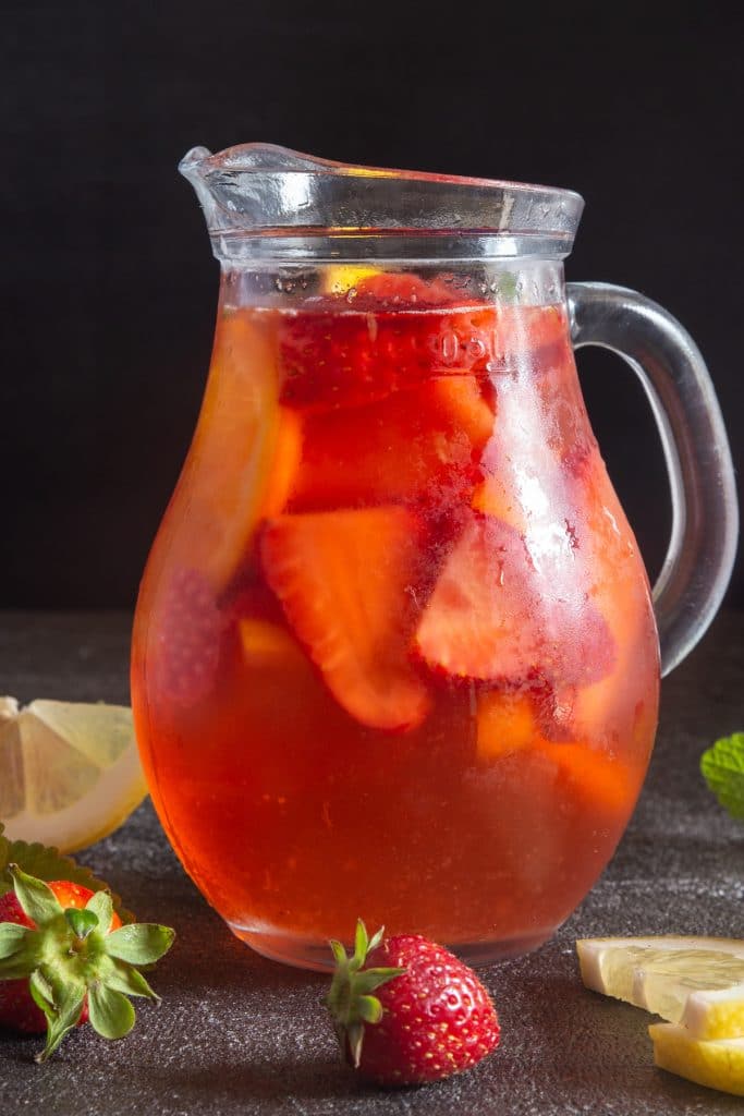 Strawberry sangria in a glass jug.