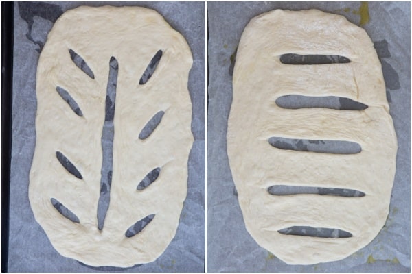 The dough shaped into fougasse with cuts on the cookie sheets.