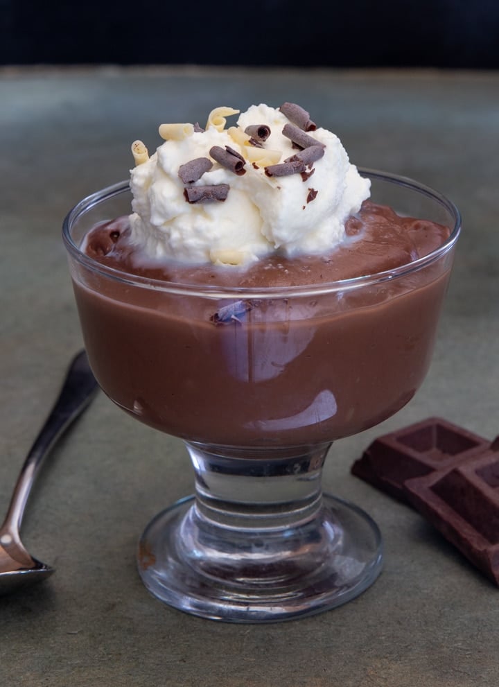 chocolate pudding in a dish with whipped cream.