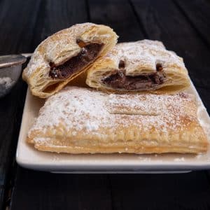 cut pastry and whole pastry on a white plate.