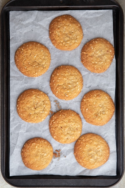 Baked cookies on a parchment paper lined cookie sheet.