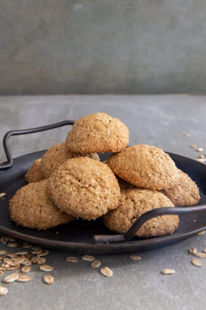 Oat cookies on a black plate.