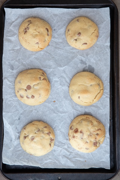 Baked cookies on a parchment paper lined sheet.