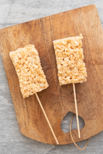 Rice Krispies Squares on a wooden board.