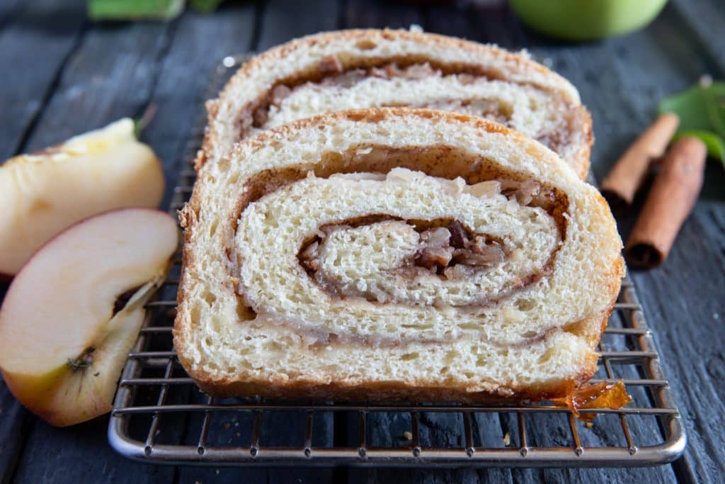 Two slices of cinnamon bread on a wire rack.