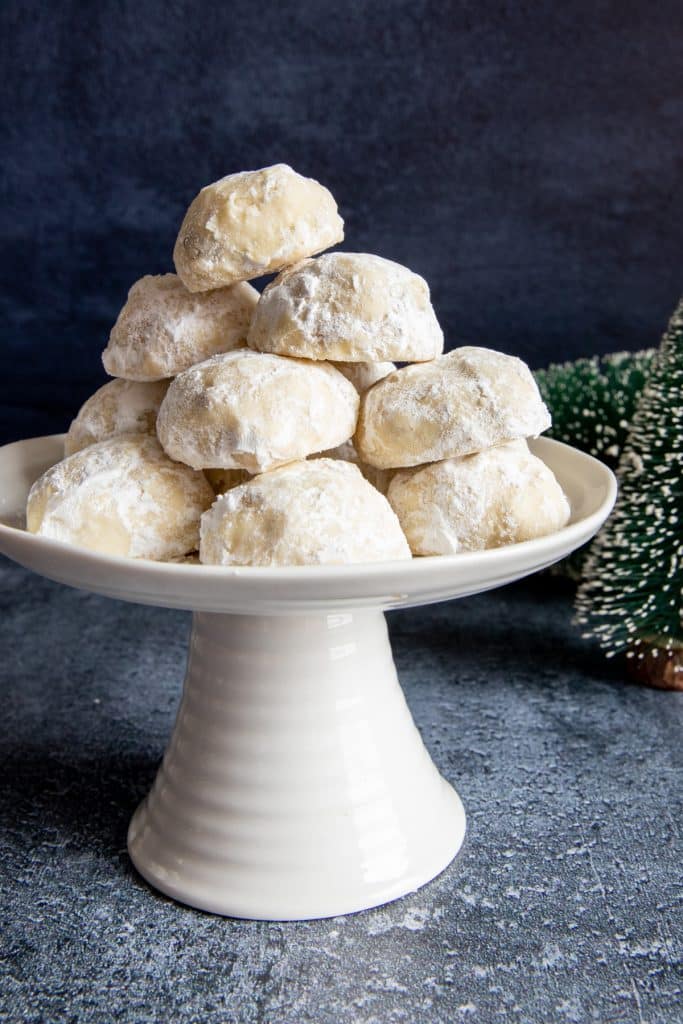 Cookies on a white cake stand.