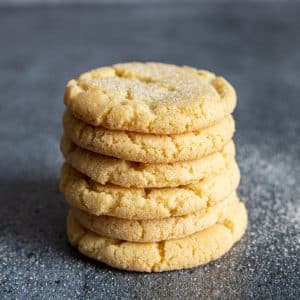 Stacked cookies with granulated sugar sprinkled around.