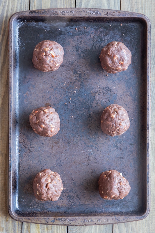 Cookie dough balls on a baking pan.