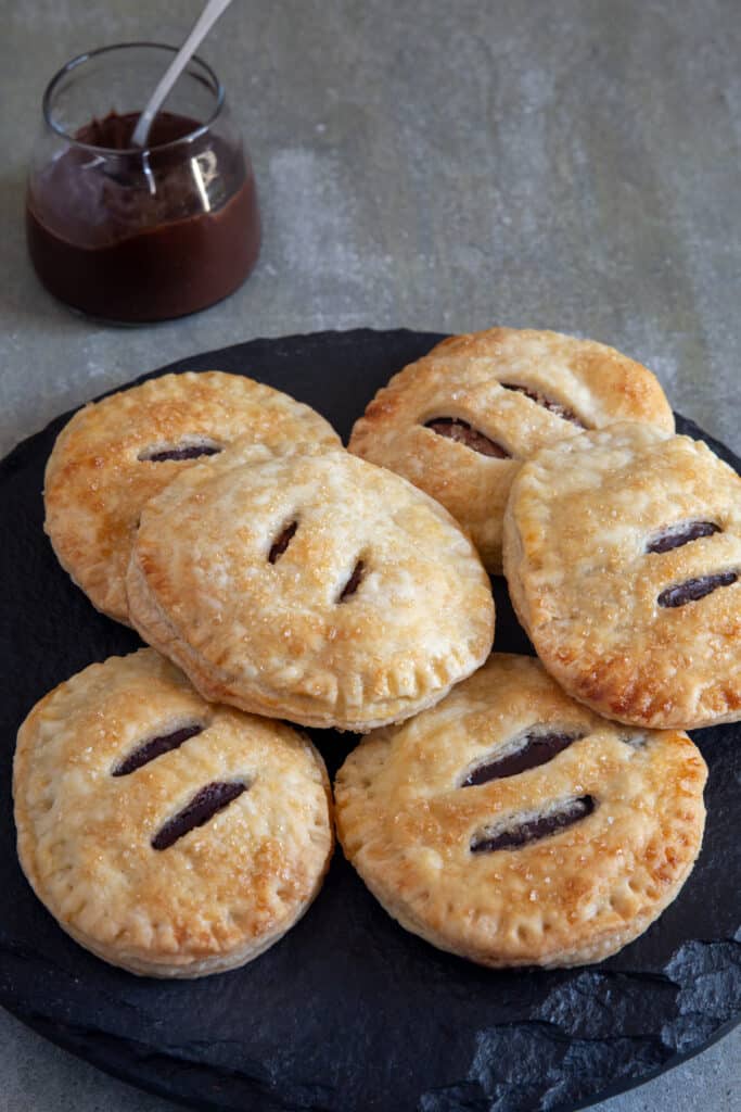 Six Handpies  on a black plate.