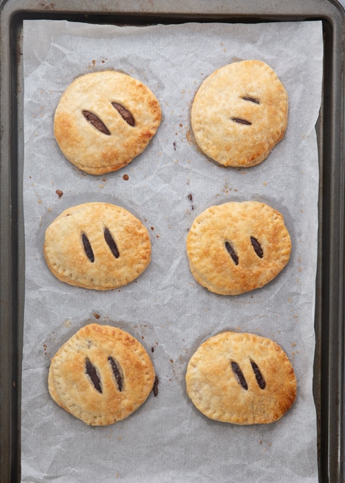 Baked hand pies on a baking sheet.