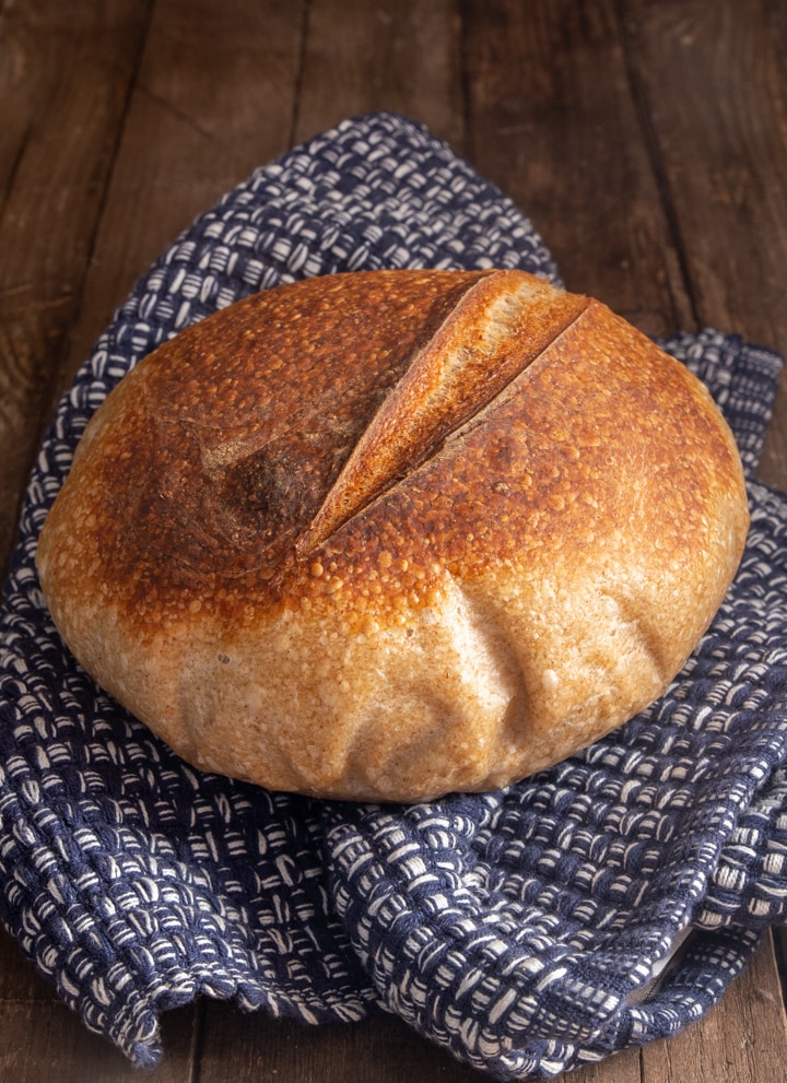 Sourdough whole wheat bread on a blue napkin.