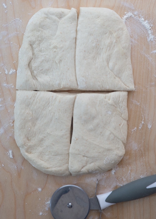 Dough shaped into a rectangle and cut into four smaller rectangles.