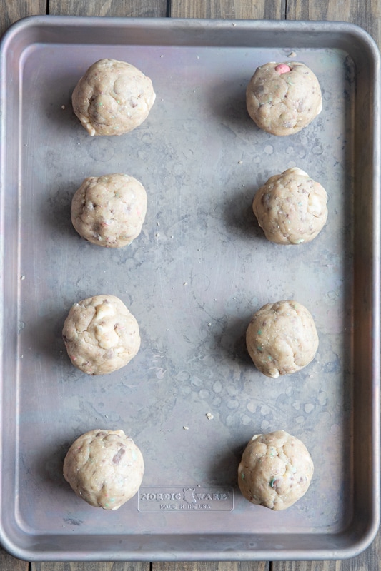 Cookies rolled into ball and placed on a baking sheet.