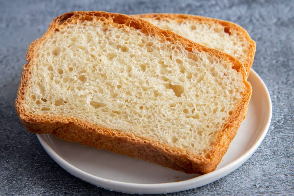 Two slices of buttermilk bread on a white plate.