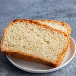 Two slices of buttermilk bread on a small white plate.