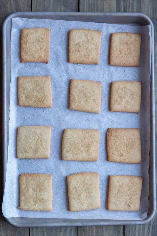 Baked tea cookies on a baking sheet.