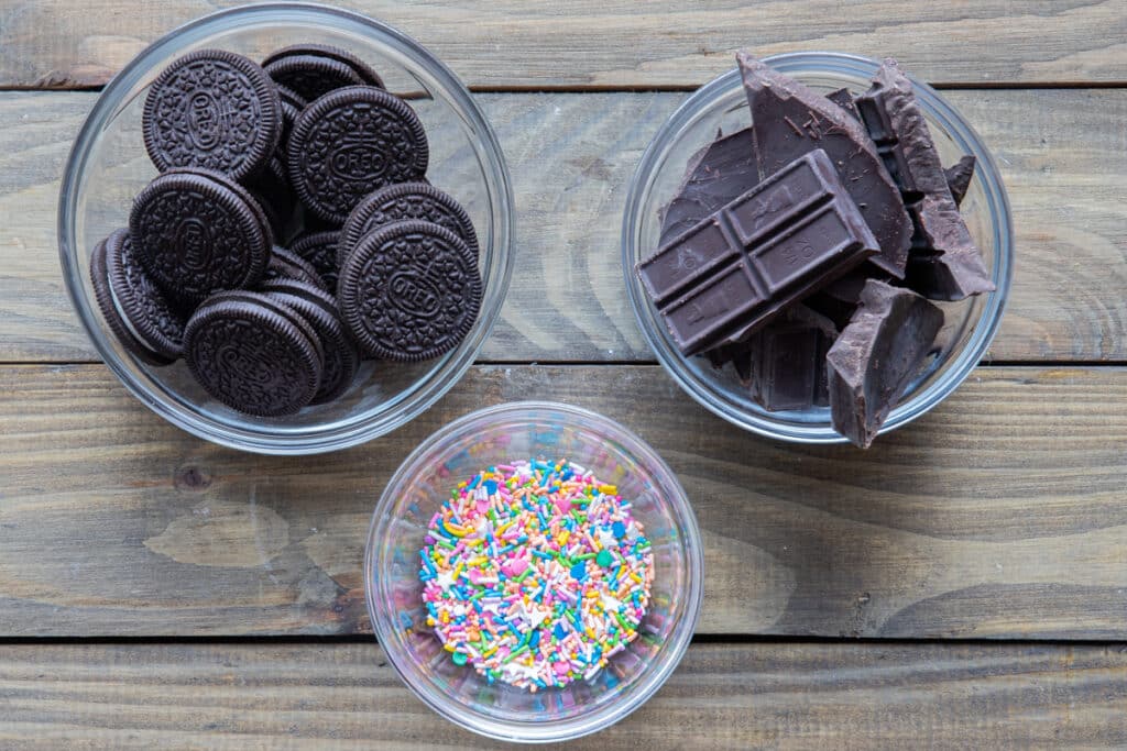 Chocolate oreos ingredients in different bowls.