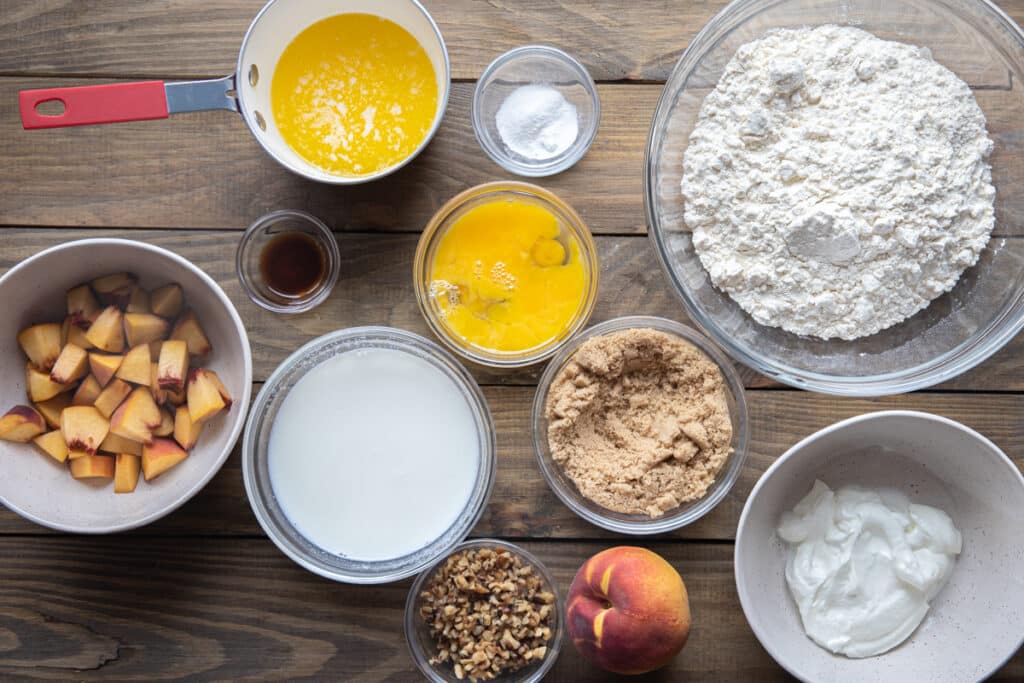 Ingredients to make the peaches and walnuts bread in separate bowls.