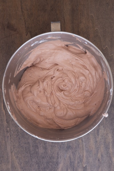 Chocolate and cream mixed together in a bowl.