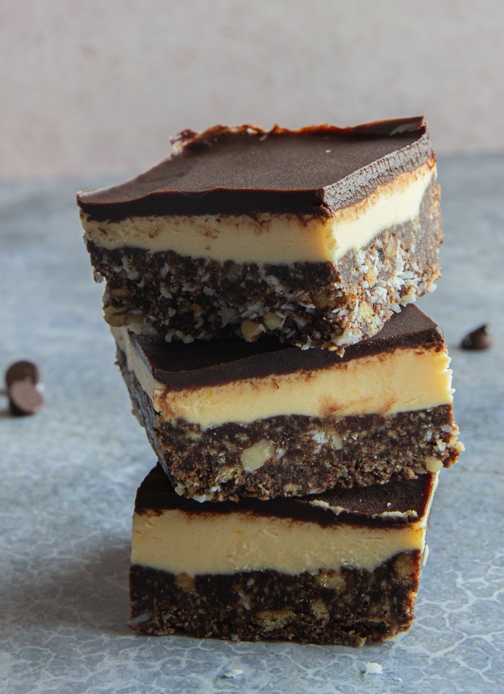 Three nanaimo bars stacked on top of each other.