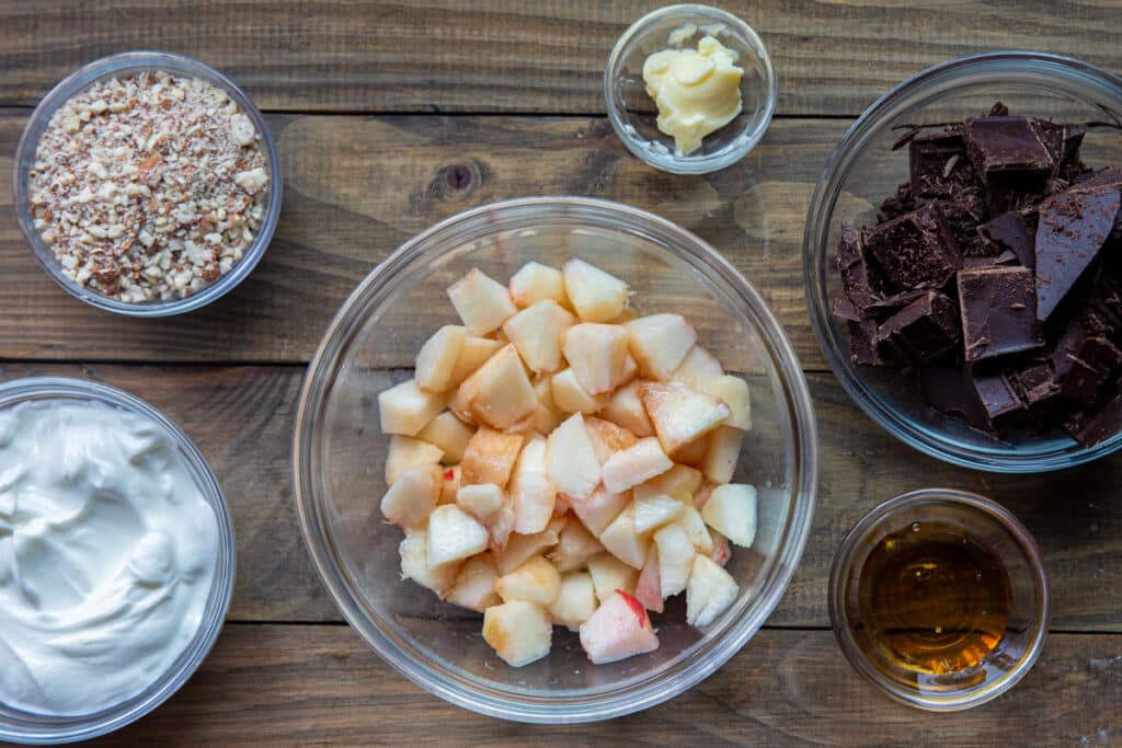 Ingredients to make the peach and almond clusters in separate bowls.