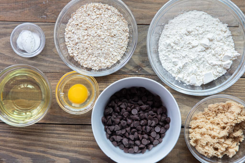 Ingredients to make double chocolate oatmeal bars in separate bowls.